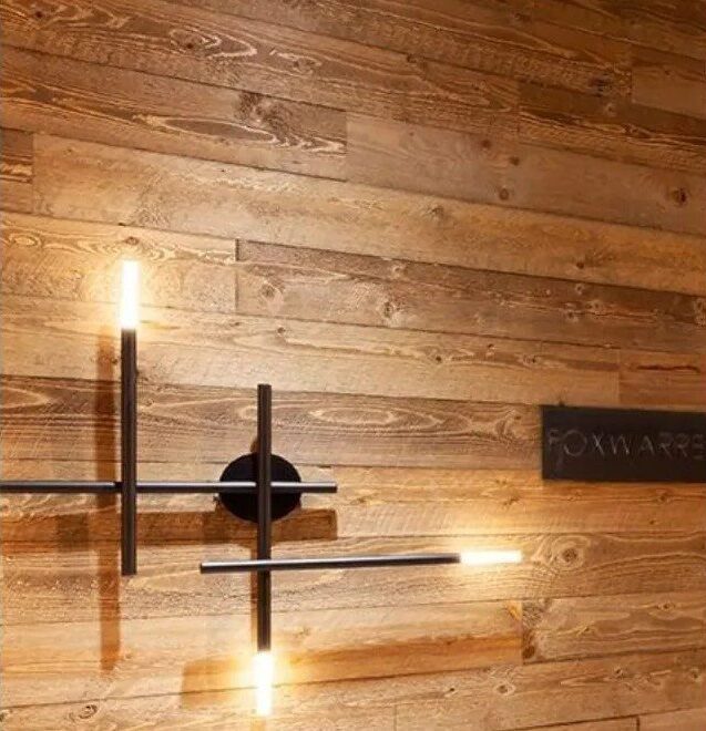 Linear wall sconce on wood paneling
