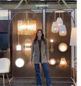 Visitor in front of the Century lighting display at IDS